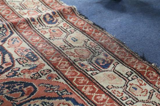 A Serabend rug with all-over boteh design in red, pink, blue and ivory, 195cm x 125cm